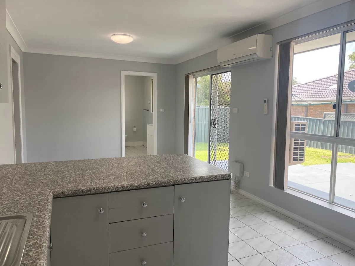 Kitchen bench and tiled family room with air conditioner
