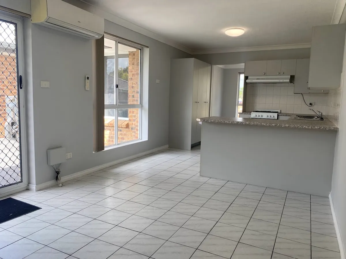 Tiled family room with air conditioner off the kitchen